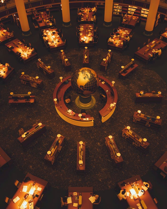 Warm-toned library scene with globe centerpiece and study lights.